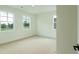 Well-lit bedroom featuring neutral carpet, white walls and trim, and a window showcasing the outside at 1514 Gatekeeper Ter, Marietta, GA 30066