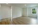 Bright bedroom with light wood flooring, white walls and trim, and a view of trees at 1514 Gatekeeper Ter, Marietta, GA 30066