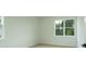 Well-lit bedroom with white walls, trim, and a window offering a view of trees at 1514 Gatekeeper Ter, Marietta, GA 30066