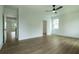 Bedroom with light walls, ceiling fan, and wood flooring at 1514 Gatekeeper Ter, Marietta, GA 30066