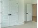 Bright room showcasing neutral carpet, white walls and trim, and double doors at 1514 Gatekeeper Ter, Marietta, GA 30066
