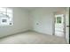 Bright bedroom featuring neutral carpet, white walls and trim, and a window showcasing the outside at 1514 Gatekeeper Ter, Marietta, GA 30066