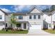 Charming two-story home with a modern design, featuring light gray siding, black trim, and a well-manicured front lawn at 1514 Gatekeeper Ter, Marietta, GA 30066