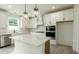 Modern kitchen featuring white cabinets, stainless steel appliances, quartz countertops and a kitchen island at 1514 Gatekeeper Ter, Marietta, GA 30066