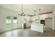 Bright kitchen featuring white cabinets, stainless steel appliances, quartz countertops and a stylish lighting at 1514 Gatekeeper Ter, Marietta, GA 30066