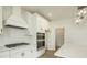 Close up of a modern kitchen featuring white cabinets, quartz countertops and stainless steel appliances at 1514 Gatekeeper Ter, Marietta, GA 30066
