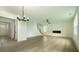 Spacious living room with modern fireplace, ceiling fan, and neutral walls, with stairs, creating an open and welcoming atmosphere at 1514 Gatekeeper Ter, Marietta, GA 30066