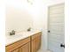 Bathroom featuring double sink vanity with wooden cabinets and gold hardware at 6490 Mockingbird Rd, Cumming, GA 30028