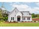 Charming two-story home with gray siding, white brick accents, and a well-manicured front lawn at 6490 Mockingbird Rd, Cumming, GA 30028