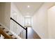 Bright hallway with hardwood floors, white walls, and staircase leading up to the next level at 6490 Mockingbird Rd, Cumming, GA 30028