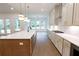 Modern kitchen with stainless steel appliances, a large island, and bright white cabinets at 6490 Mockingbird Rd, Cumming, GA 30028