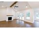 Living room with a brick fireplace, vaulted ceilings, and French doors to the outdoor area at 6490 Mockingbird Rd, Cumming, GA 30028