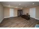 Finished basement with a desk, bookcase and wood-look flooring at 942 Heathchase Dr, Suwanee, GA 30024