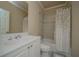 Bright bathroom with white vanity, a single sink and a shower over tub at 942 Heathchase Dr, Suwanee, GA 30024