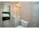 Well-lit bathroom boasts a white vanity and tile-surround bathtub with shower at 942 Heathchase Dr, Suwanee, GA 30024