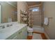 Bathroom featuring vanity, a shower-tub combo, and open shelving at 942 Heathchase Dr, Suwanee, GA 30024