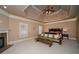 The main bedroom features a decorative trey ceiling and a fireplace at 942 Heathchase Dr, Suwanee, GA 30024