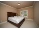 Bedroom with a wooden bed frame and carpet flooring at 942 Heathchase Dr, Suwanee, GA 30024