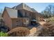 Expansive rear exterior with a patio and lush landscaping showcase the backyard retreat at 942 Heathchase Dr, Suwanee, GA 30024