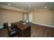 Home office offers ample space, wood-look floors, and bright recessed lighting at 942 Heathchase Dr, Suwanee, GA 30024