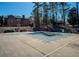 Community Pool is covered for the off-season, and surrounded by mature landscaping at 942 Heathchase Dr, Suwanee, GA 30024