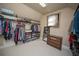 Walk-in closet has carpeted floor and shelving at 942 Heathchase Dr, Suwanee, GA 30024