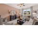 Living room with a modern layout, comfortable seating, a ceiling fan, and outside view at 150 Oakchase Park Lane, Hampton, GA 30228