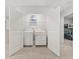 Convenient laundry room features modern washer and dryer units, with easy access from bedroom area at 3121 Greyton Dr, Buford, GA 30519