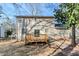View of the house's rear exterior featuring a spacious yard, wooden deck, and sliding glass doors at 5438 Zachary Dr, Stone Mountain, GA 30083
