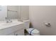 Bathroom with single sink vanity, toilet with protective tape, and a mirror at 5438 Zachary Dr, Stone Mountain, GA 30083