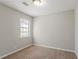 A bedroom with a carpeted floor and a window providing natural light at 5438 Zachary Dr, Stone Mountain, GA 30083