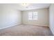 Neutral bedroom with a carpeted floor, a window, and overhead lighting at 5438 Zachary Dr, Stone Mountain, GA 30083
