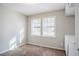 Neutral bedroom with two windows, carpeted floor, with built in shelving and drawers at 5438 Zachary Dr, Stone Mountain, GA 30083