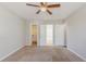 Spacious bedroom with tan carpet, ceiling fan and access to closet and bathroom at 5438 Zachary Dr, Stone Mountain, GA 30083