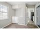 Neutral bedroom with a storage/desk area with cabinets, and an entrance to the kitchen at 5438 Zachary Dr, Stone Mountain, GA 30083