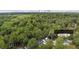 Aerial view of the property surrounded by lush greenery, with the city skyline visible in the distance at 1551 Avon Ave, Atlanta, GA 30311