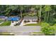 Aerial view of a home nestled among trees with a long driveway and a fenced yard at 1551 Avon Ave, Atlanta, GA 30311