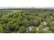 Aerial shot of the house surrounded by mature trees, with the Atlanta skyline in the background at 1551 Avon Ave, Atlanta, GA 30311