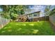 Backyard featuring lush green lawn and wooden deck on a white two-story home at 1551 Avon Ave, Atlanta, GA 30311