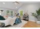 Serene bedroom with hardwood floors, large windows, and vaulted ceiling at 1551 Avon Ave, Atlanta, GA 30311