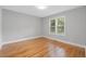 Bright bedroom featuring hardwood floors, fresh paint and a window letting in natural light at 1551 Avon Ave, Atlanta, GA 30311