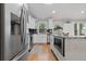 Updated kitchen with white cabinetry, stainless steel appliances, and granite countertops on island at 1551 Avon Ave, Atlanta, GA 30311