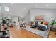 Bright living room featuring hardwood floors, modern decor, and an open layout to kitchen at 1551 Avon Ave, Atlanta, GA 30311