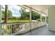 Long, covered porch with white railings and columns overlooking a well-manicured lawn at 1551 Avon Ave, Atlanta, GA 30311