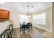 Cozy dining area with modern chandelier and hardwood floors, perfect for Gathering meals at 3277 Bluejay Lane # 41, Alpharetta, GA 30022