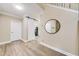 Inviting foyer with wood-look floors, a sliding barn door, an accent mirror, and access to the staircase at 3277 Bluejay Lane # 41, Alpharetta, GA 30022