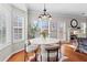 Bright breakfast nook featuring a modern light fixture and a cozy seating arrangement by the windows at 3760 Lake Point Blvd, Suwanee, GA 30024