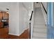 Inviting foyer featuring hardwood floors, staircase, and an open view into the kitchen at 3760 Lake Point Blvd, Suwanee, GA 30024