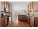 Spacious kitchen with wood cabinets, stainless steel appliances, and hardwood floors at 3760 Lake Point Blvd, Suwanee, GA 30024