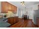 Kitchen featuring granite countertops, stainless steel appliances, and hardwood flooring at 3760 Lake Point Blvd, Suwanee, GA 30024